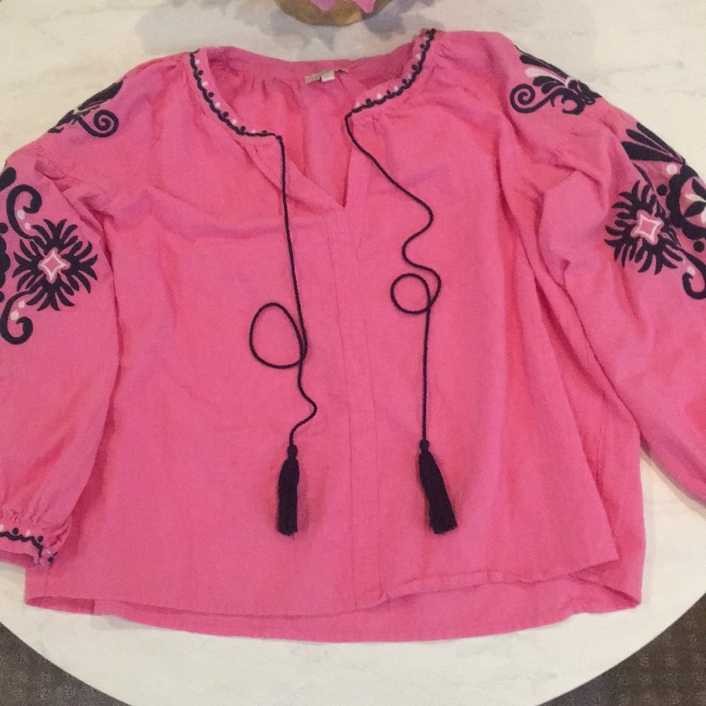 Pink top with embroidery and tassels